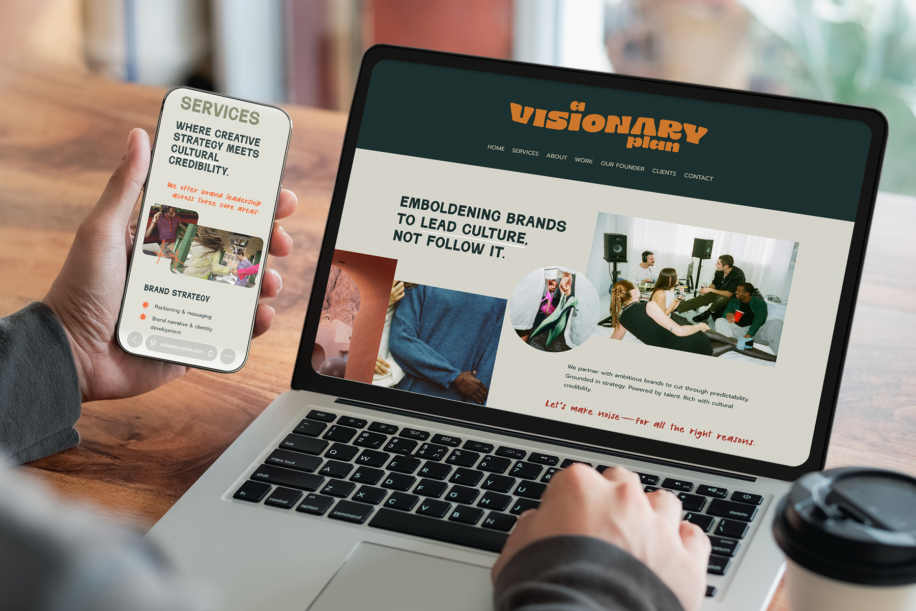 A mock up of the A Visionary Plan website designed by Gray Creative Studio on a laptop and a smart phone with a hand holding the phone and the other hand on the laptop keyboard.